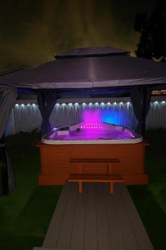 a hot tub with purple lights in a gazebo at Palmera House in Tampa with Hot Tub 10 minutes from Airport & Busch Gardens in Tampa