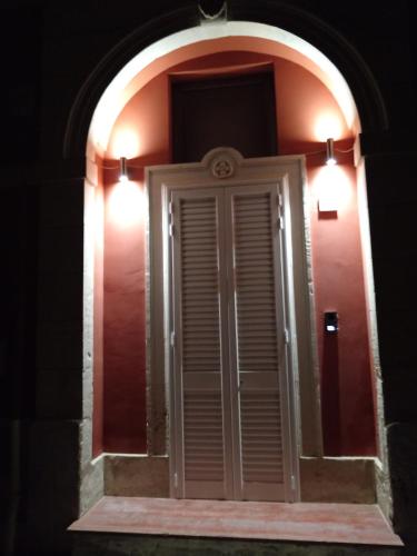 a window with two lights on a red wall at B&B Casa dolce casa in Cutrofiano