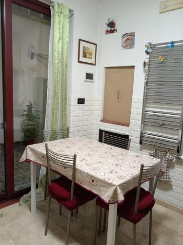 a table and chairs in a room with a window at B&B Casa dolce casa in Cutrofiano