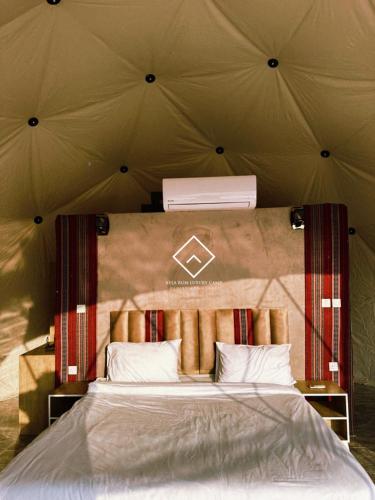 a bedroom with a large bed in a tent at ALYA RUM LUXURY Camp in Wadi Rum