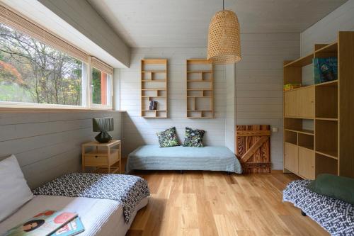 a bedroom with two beds and a window at 4 Strony Lasu in Gołaczów