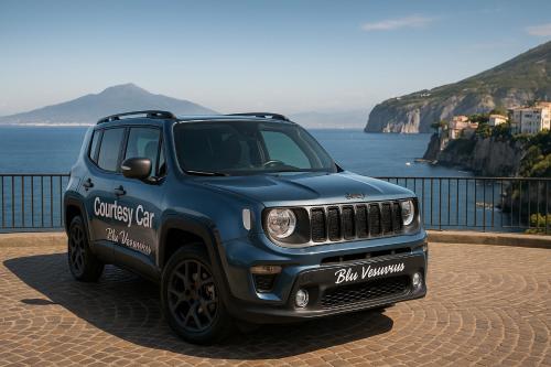 a blue jeep parked next to the ocean at Blu Vesuvius Sorrento in Sorrento