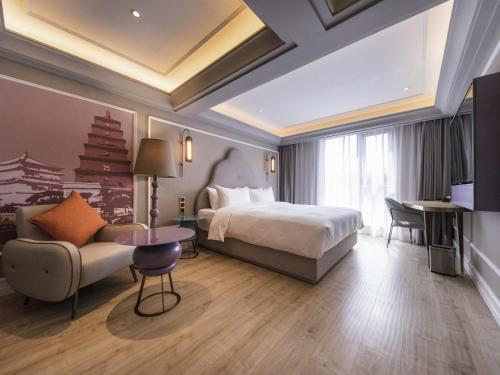 Ένα ή περισσότερα κρεβάτια σε δωμάτιο στο Mercure Xi'an Downtown