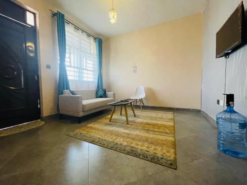 a living room with a couch and a table at A Oasis Taveta in Taveta