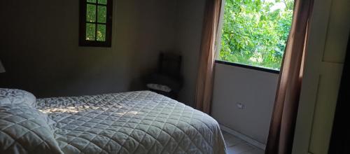 una camera da letto con un letto e una finestra di La morita hospedaje a Brandsen