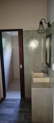a bathroom with a sink and a mirror at La morita hospedaje in Brandsen