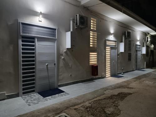 a bathroom with two doors and a television on the wall at AparthouseRisorgimento MISENO in Frattamaggiore