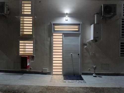 a door in the side of a building with windows at AparthouseRisorgimento BORBONE in Frattamaggiore