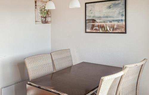 a dining room with a table and two chairs at Amazing Home In Hanstholm With Private Swimming Pool, Can Be Inside Or Outside in Pugdal
