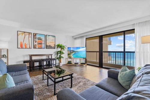 a living room with a couch and a table at Spacious Waikiki Beach 2BR-Ocean View-Free Parking in Honolulu