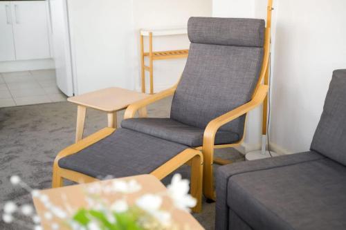 two chairs and a couch in a room at Brightly Renovated St Kilda Apt with Sea Views in Melbourne