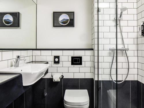 a bathroom with a toilet and a sink and a shower at ibis Wakefield East-Castleford in Wakefield