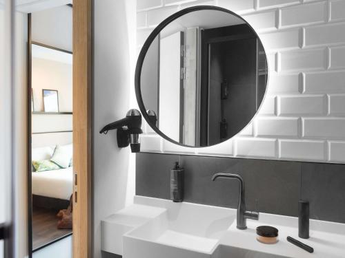 a bathroom with a sink and a mirror at ibis Brussels Centre Chatelain in Brussels