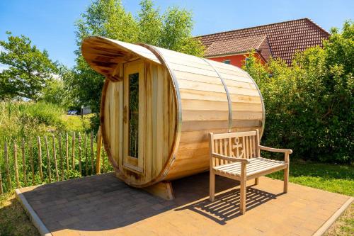 a large wooden boat sitting next to a chair at Ferienhaus Marvin In Beckerwitz in Gramkow