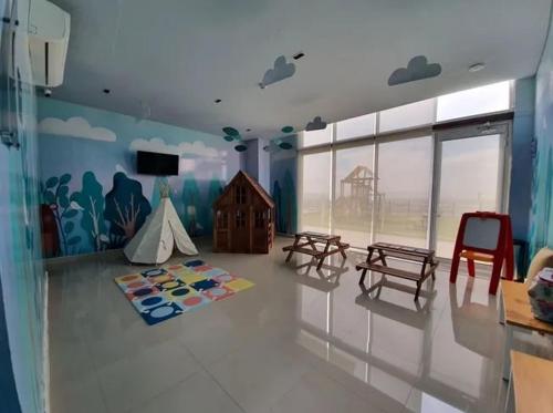 a room with a playroom with a tent and a table at Luxury apartment with panoramic view in tower in Laborcillas