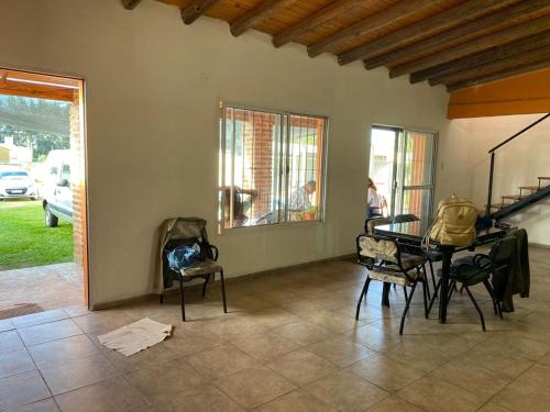 a living room with a table and chairs and a window at La Perla del Yuqueri in Concordia