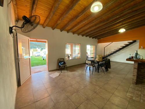 a living room with a table and a staircase at La Perla del Yuqueri in Concordia