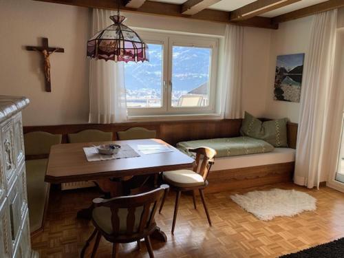a living room with a couch and a table and a window at Ferienwohnung Rosa in Fritzens