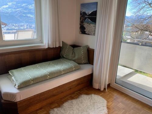 a bench in a room with a large window at Ferienwohnung Rosa in Fritzens