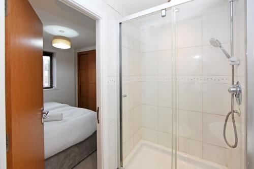 a bathroom with a shower and a bath tub at Albion Street Apartments in Wolverhampton