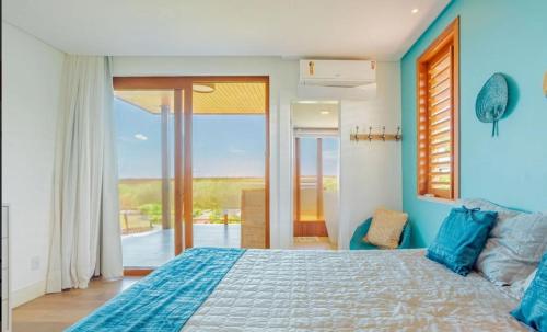 une chambre avec un lit aux murs bleus et une fenêtre dans l'établissement Casa PRAIA DO FORTE, à Praia do Forte