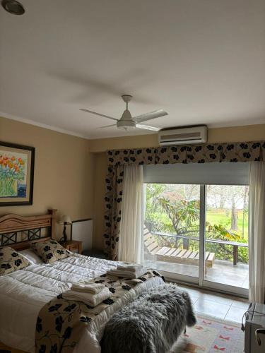 a bedroom with a bed and a large window at PATO NEGRO in Tigre