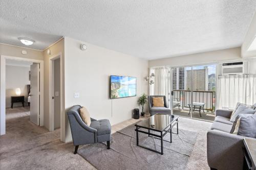 a living room with a couch and chairs at Ocean View from Lanais-2 Blocks to Waikiki Beach in Honolulu