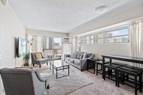 a living room with a couch and a table at Ocean View from Lanais-2 Blocks to Waikiki Beach in Honolulu