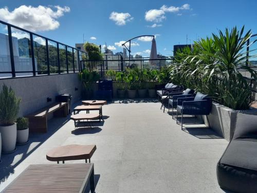 a balcony with tables and benches on a building at Aurea 310 in Tambaú