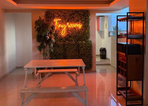 a bench in front of a new smoking sign in a store at Tiny Rooms in Toluca