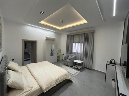 a bedroom with a large bed and a television at قمرة قباء Quba moon3 in Al Madinah