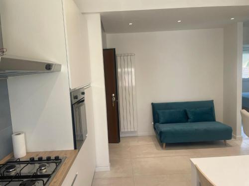a living room with a blue couch in a kitchen at Appartamento Helena Duomo in Pisa
