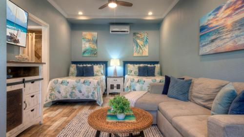 a living room with a couch and a table at 2 Pools Beach Boardwalk Access Studio Sleeps 5 Beach Bungalow by AvantStay in Port Aransas