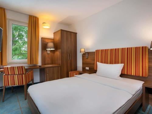 Ένα ή περισσότερα κρεβάτια σε δωμάτιο στο Greet hotel Darmstadt - an Accor hotel -