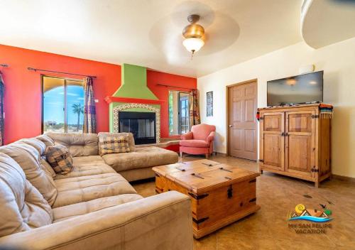 a living room with a couch and a tv at Casa Talebi El Dorado Ranch San Felipe WiFi in Playa El Paraíso
