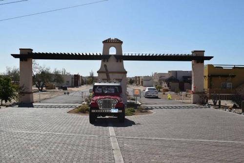 a red jeep parked in a parking lot at Los Sahuaros San Felipe Rental in Don Pancho