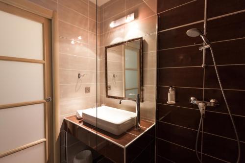 a bathroom with a sink and a mirror at Hôtel Funtana Marina in LʼÎle-Rousse