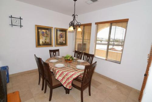 a dining room with a table and some chairs at El Dorado Ranch Vacation Rental Condo 25-1 | 18-Hole Golf in Playa El Paraíso