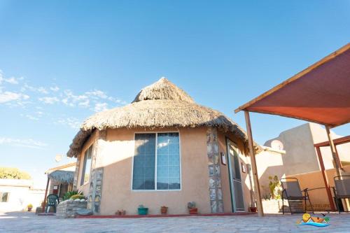 a small hut with a thatched roof on a street at 1-Bedroom Beach Studio - Serene getaways. in San Felipe