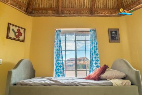 a bed in a room with a window at 1-Bedroom Beach Studio - Serene getaways. in San Felipe