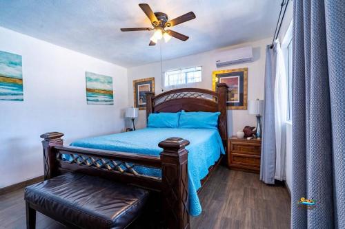 a bedroom with a bed and a ceiling fan at Huge Family 5 bedroom sleeps 16 with private pool home in San Felipe