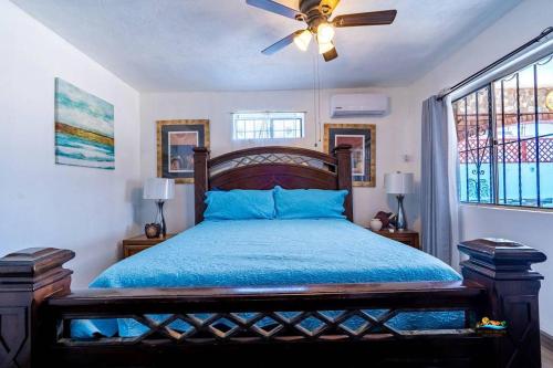 a bedroom with a bed and a ceiling fan at Huge Family 5 bedroom sleeps 16 with private pool home in San Felipe