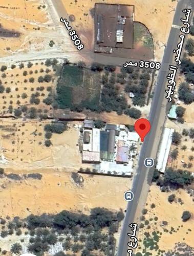 an aerial view of a house with a red dot at استراحة رملة ليوا in Al Aţīr