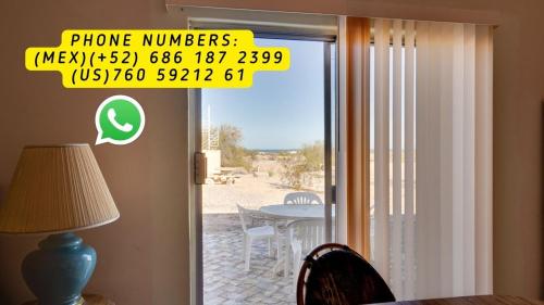 a sliding glass door with a view of a table at El Dorado Ranch San Felipe Rental - Judy`s Casita in Playa El Paraíso
