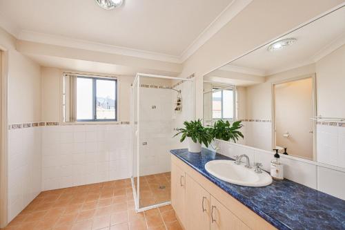 a bathroom with a sink and a shower at The Drift at Cathie in Lake Cathie