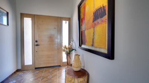 a hallway with a painting and a vase on a table at Amazing El Dorado Ranch Pool house La Kasa 53 in Playa El Paraíso