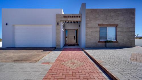 a building with a door and a brick driveway at Amazing El Dorado Ranch Pool house La Kasa 53 in Playa El Paraíso