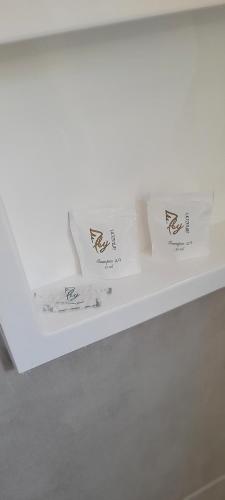 two boxes sitting on top of a white shelf at Refúgio ensolarado a poucos passos do mar in Navegantes