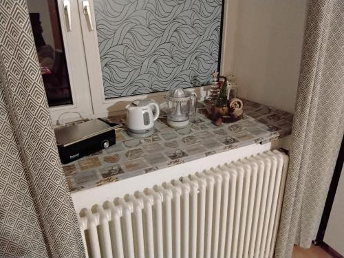 a bathroom counter with a mirror and a radiator at Alpine's Apartment in Arnoldstein