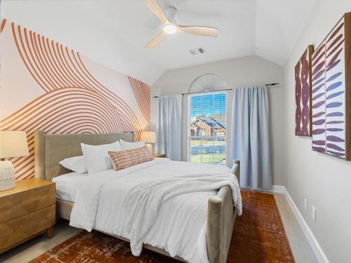 a bedroom with a bed and a window at Boho Dreamscape 4BD Game Room Pool in The Colony